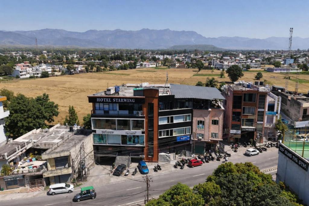 an aerial view of a city with a building at Hotel Starwing in Pāonta Sāhib