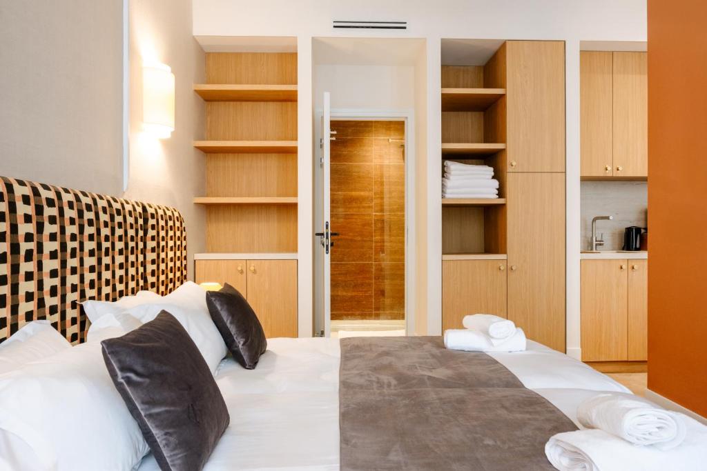 a bedroom with a bed with white pillows at Résidence Monceau Jadin in Paris
