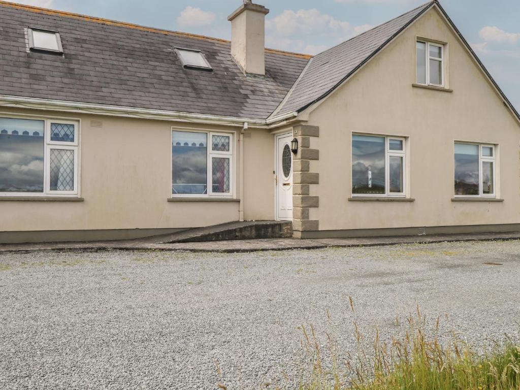 a house with a driveway in front of it at Islands Inn in Louisburgh