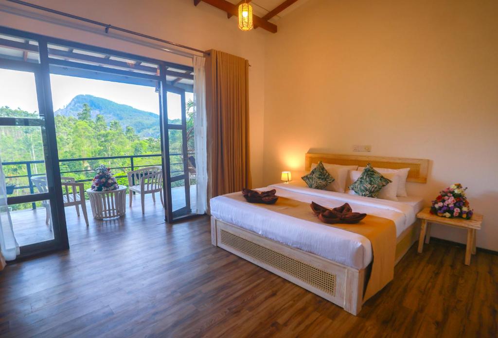 a bedroom with a bed and a large window at Amber Reach Cottages in Ella