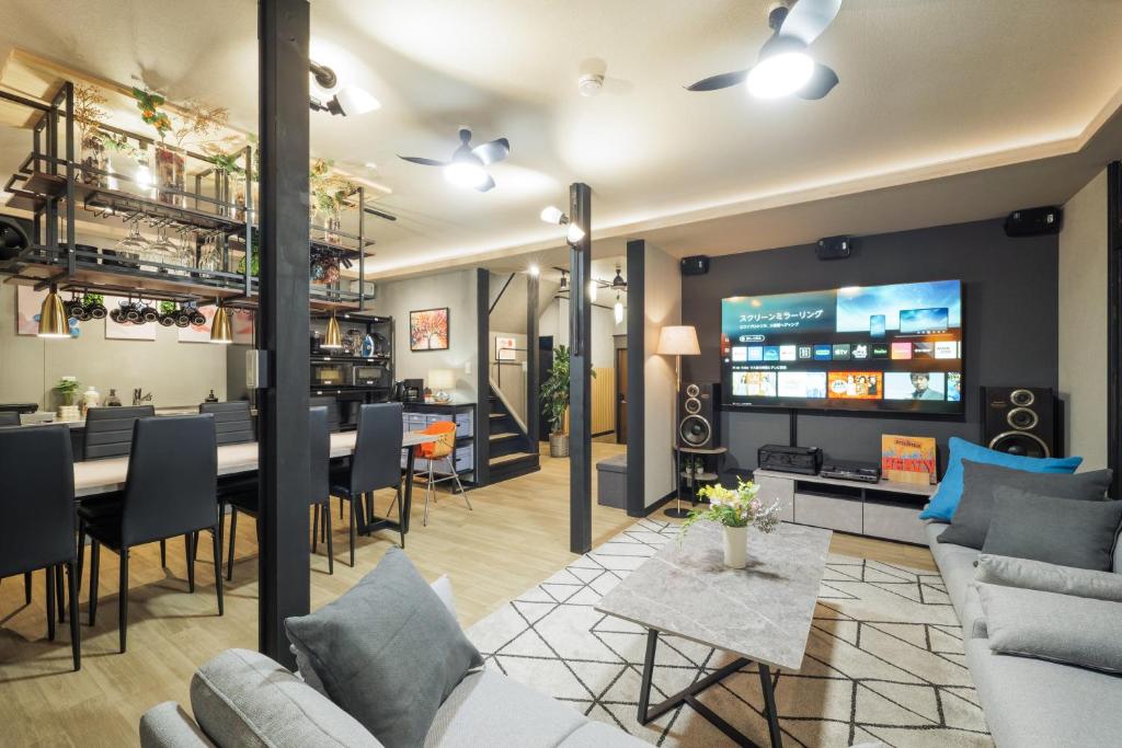a living room with a table and a tv at SNUGGLE2222 Odawara Nakacho in Odawara