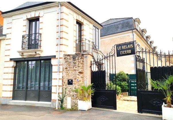 a building with a sign in front of it at Relais Fléchois in La Flèche