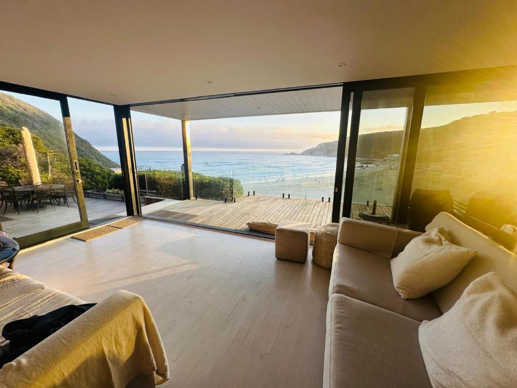 a living room with a view of the ocean at Sunset Villa Herolds Bay in Herolds Bay