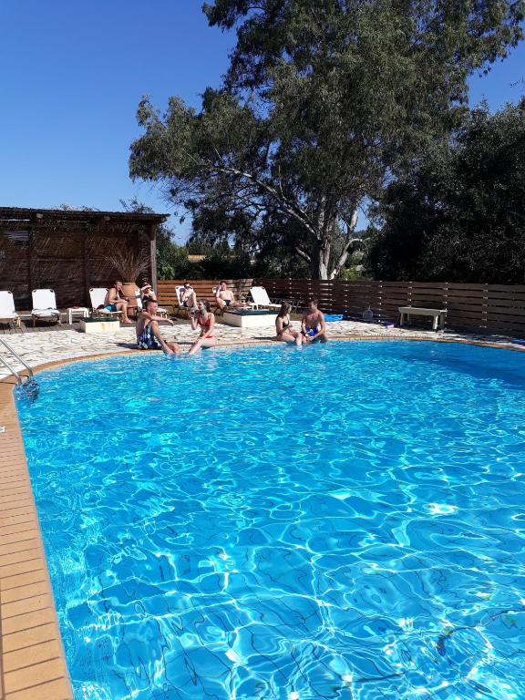 a group of people sitting in a swimming pool at Studio Gouvia Kitchenette Pool 8 in Gouvia
