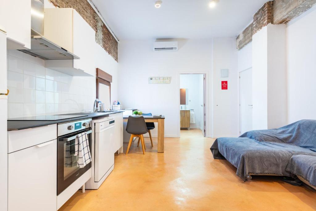 a kitchen and living room with a bed and a table at Almenara in Almenara