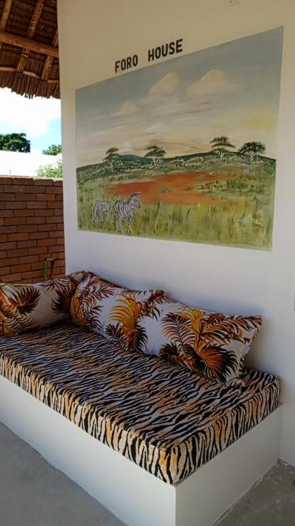 a room with a couch with pillows on it at Tranquil villa in Watamu