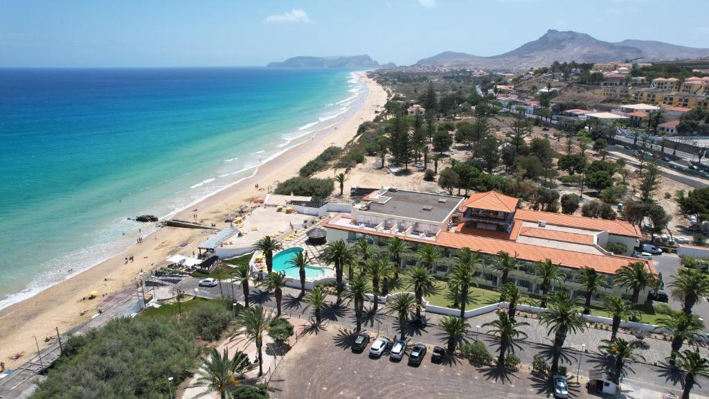 an aerial view of a beach with palm trees at Hotel Torre Praia in Porto Santo