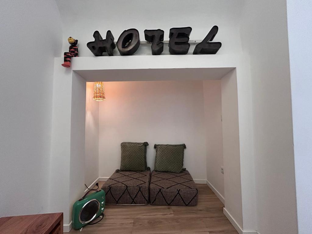 a room with a bed and a sign that reads vote at Casa da Maria in Évora