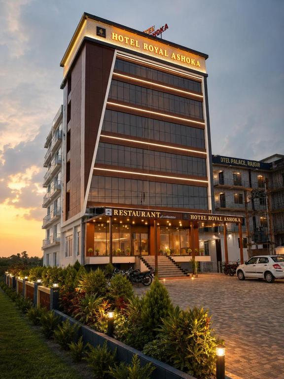 a hotel building with a car parked in front of it at Hotel Royal Ashoka in Rājgīr