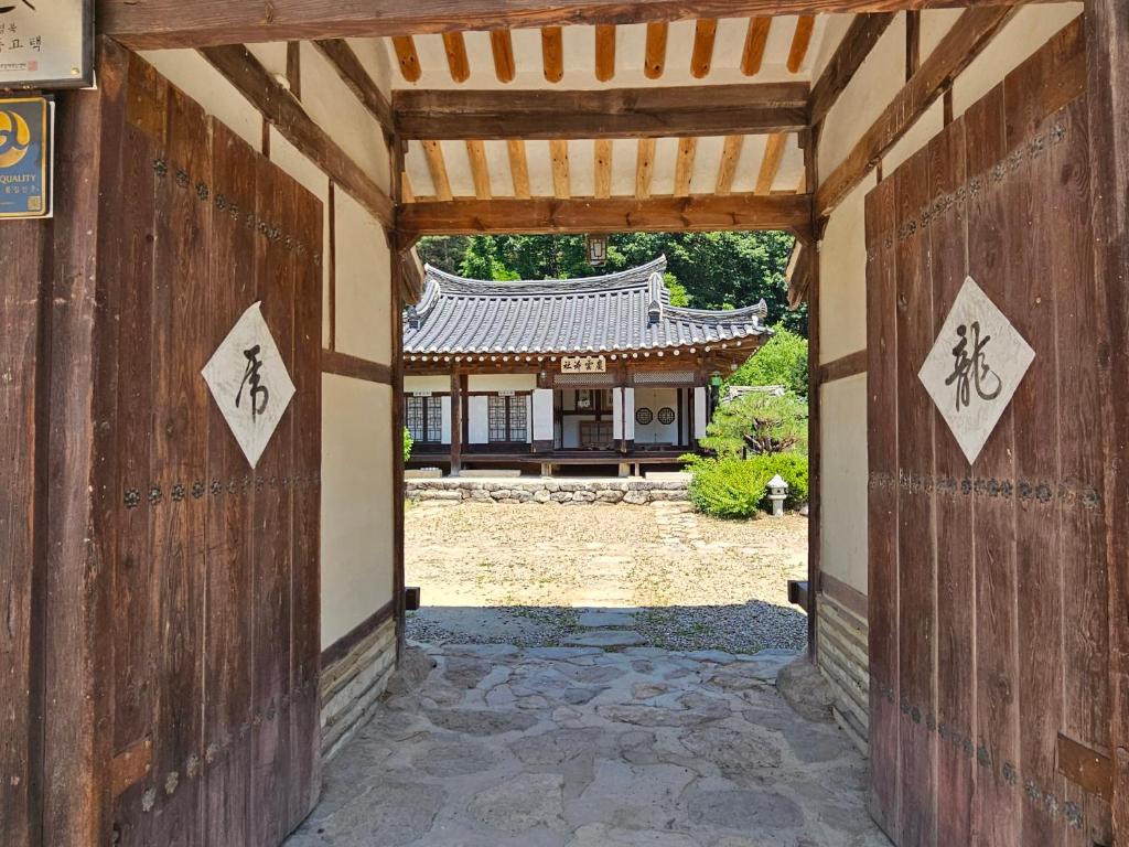 an entrance to a building with an asian roof at Tohyang Traditional House in Bonghwa