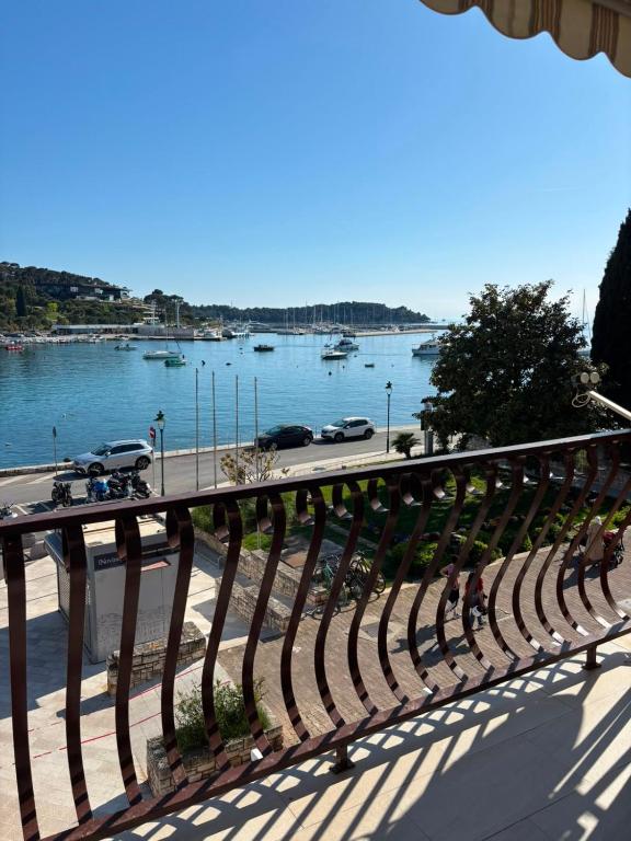 a bench on a balcony with a view of a river at Apartment Adriatic Sea View Zoe in Rovinj