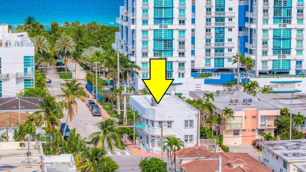 an aerial view of a city with a yellow arrow at Blue Flamingo Suites in Miami Beach