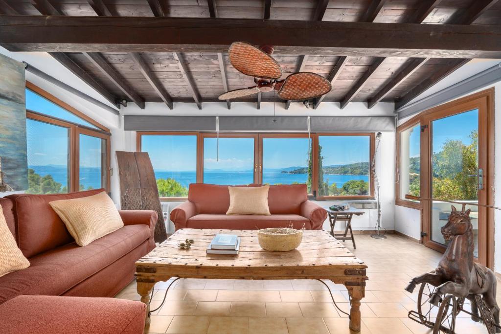 a living room with a couch and a table at Liogerma Boutique Home in Skiathos