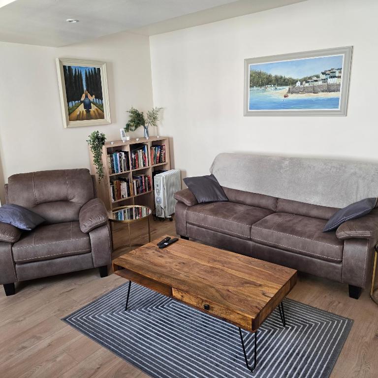 a living room with a couch and a coffee table at 18 Clifden Court in Clifden