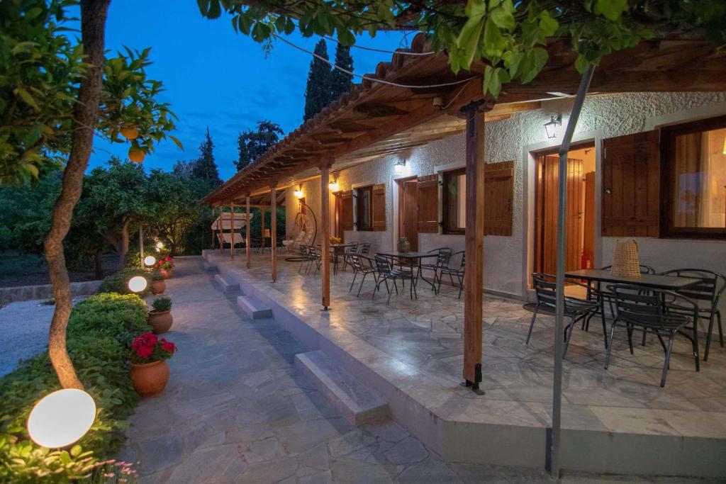 a patio of a house with tables and chairs at Kastraki Villas in Nafplio