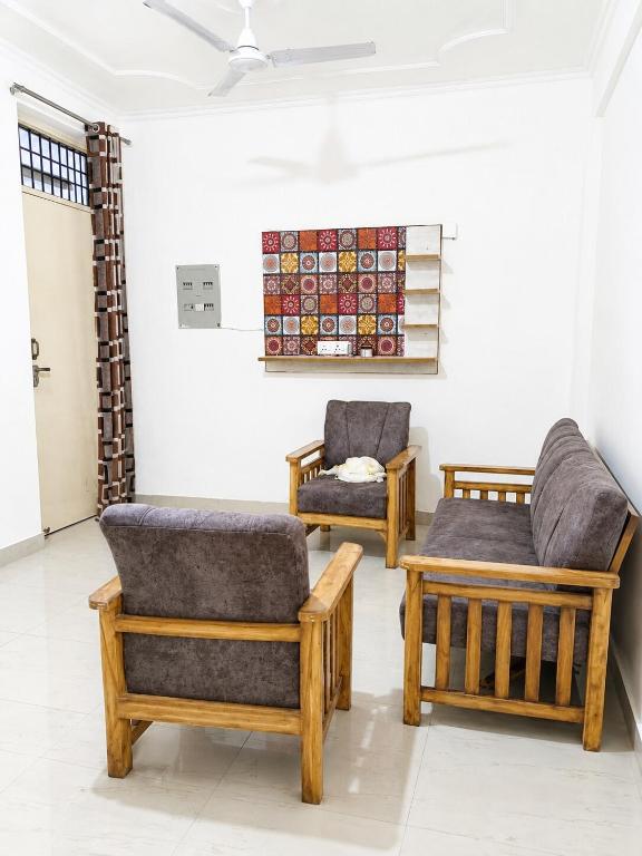 two chairs and a table in a room at 2 BHK full apartment in Mohali