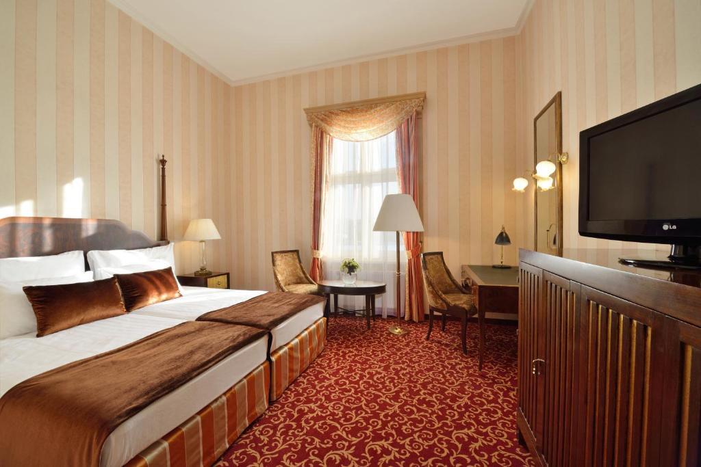 a hotel room with a bed and a television at Ensana Grand Margaret Island in Budapest