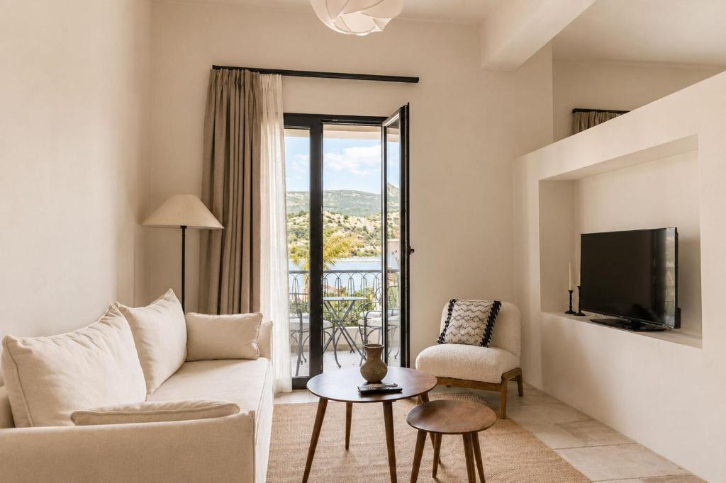 a living room with a couch and a tv at Lanu Apartments in Argostoli