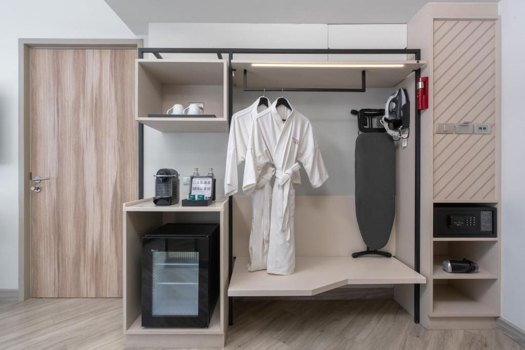 A built-in dressing and storage wall with minibar equipment.