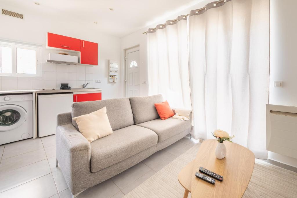 a living room with a couch and a table at Nüma Studio - Orly Paris in Montgeron