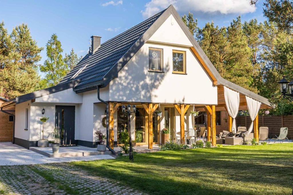 a house with a gambrel roof at Country house in Dziemiany