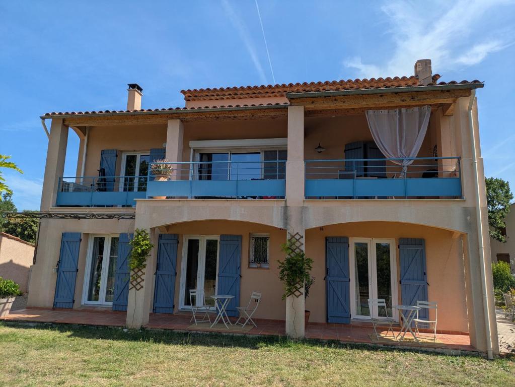 a house with chairs on the front of it at Villa Salesiae in Les Salles-sur-Verdon