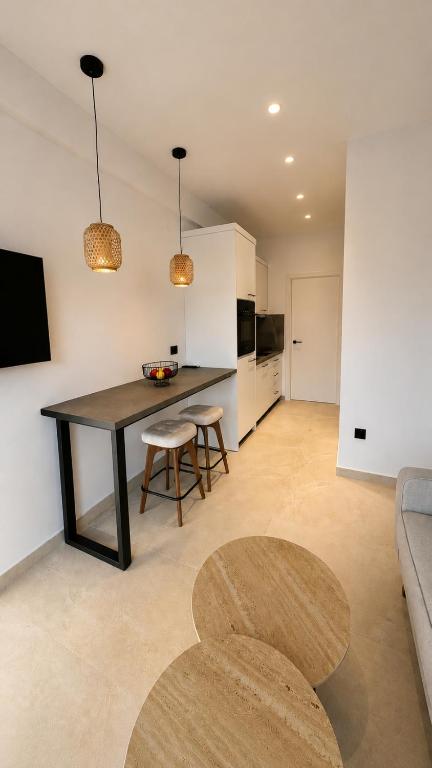 a kitchen and living room with a table and chairs at Salsedo Seaside Rooms 2 in Kanali