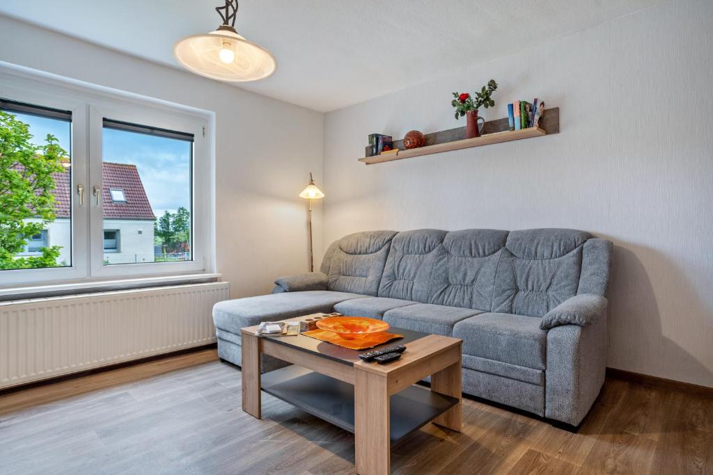 a living room with a couch and a table at Ferienwohnung 2 in Gribow