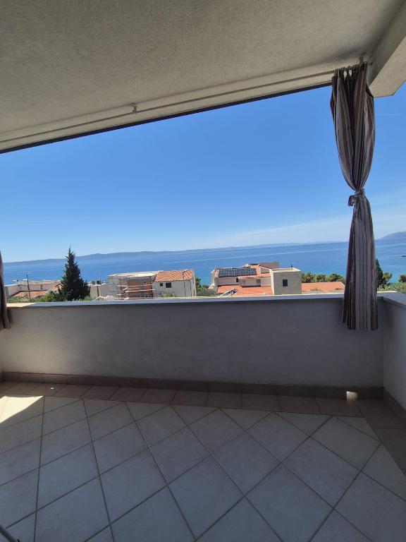 a large window with a view of the ocean at Guest House Čović in Tučepi