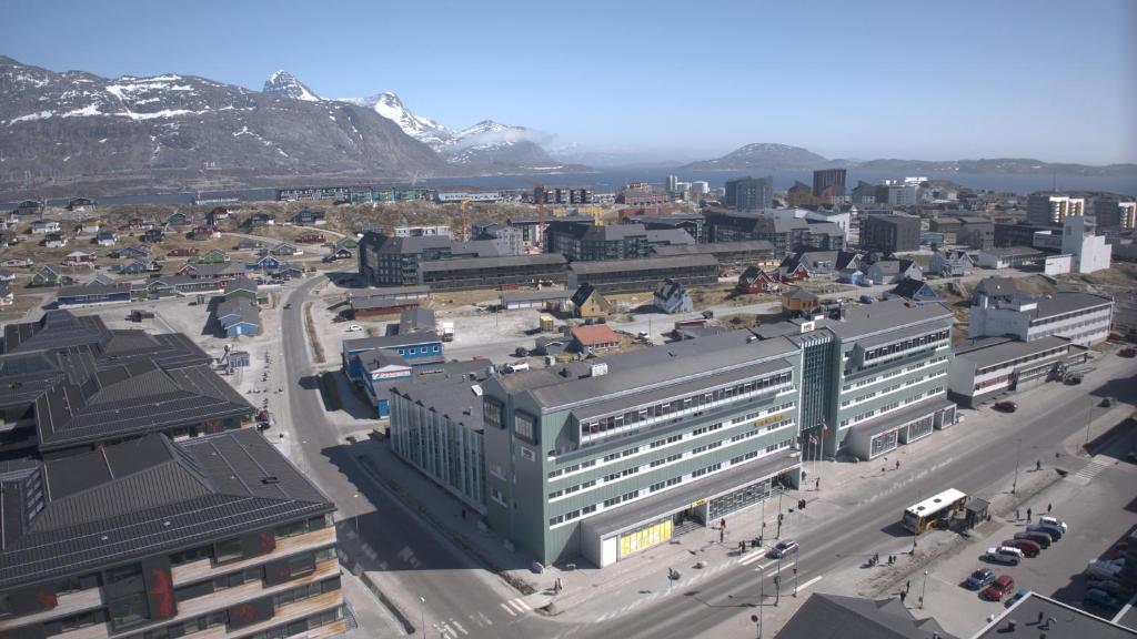 an aerial view of a city with buildings and mountains at Hotel Hans Egede in Nuuk