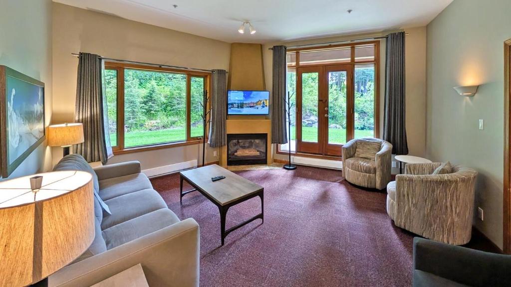 a living room with a couch and a table at Cahilty #149 in Sun Peaks