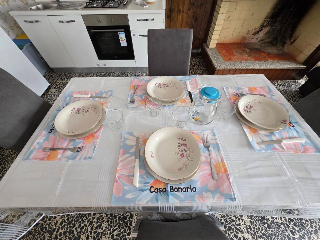 a table with plates and bowls on top of it at Casa Bonaria in Terralba