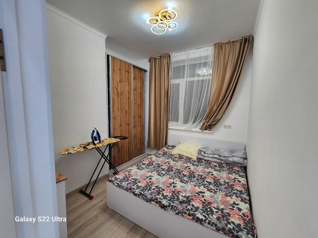 a small bedroom with a bed in a room at Коттедж в Sunny Beach in Chok-Tal
