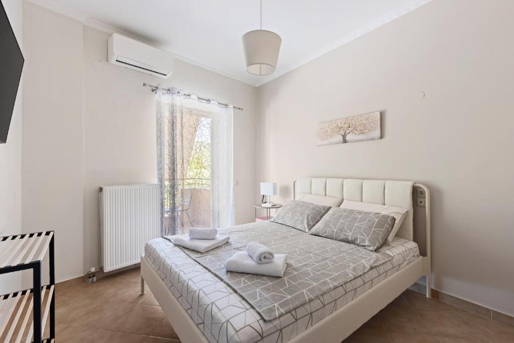 a bedroom with a bed with two towels on it at VALERIA Apartment in Vonitsa
