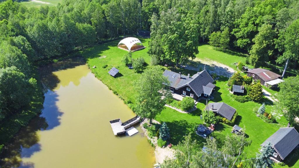 an aerial view of a house next to a river at 4gilės sodyba Alytaus rajone in Kružiūnai