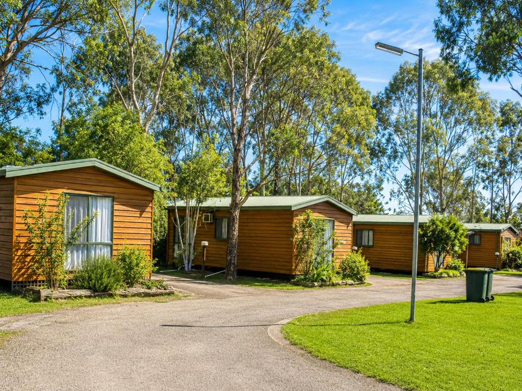 a row of cottages in a park with a street light at Shady Acres Caravan Park in Warrenheip