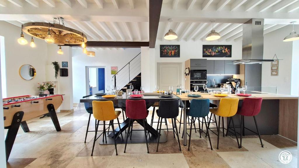 a large kitchen with a table and chairs at Le Tarare in Guipy
