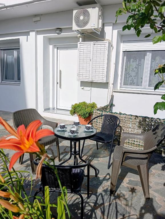 a patio with a table and chairs and a fan at Anatoli's house in Kastoria