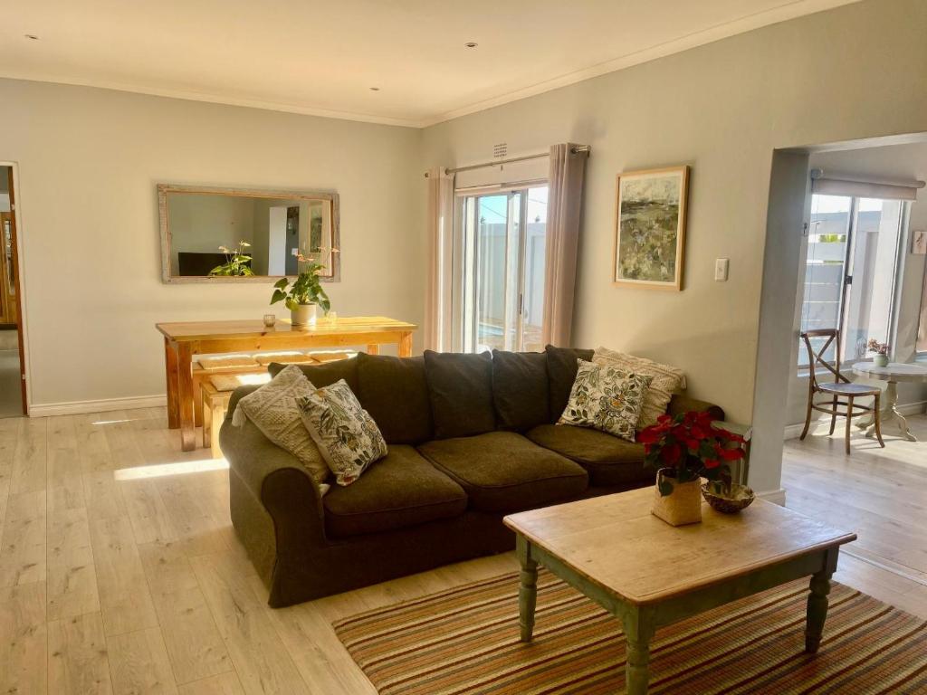 a living room with a couch and a table at The Kite Manor in Langebaan