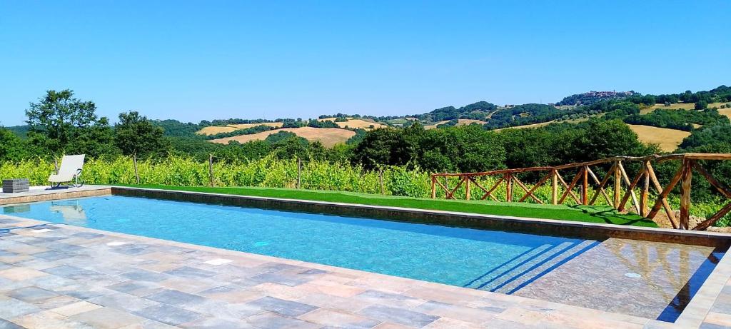 a swimming pool with a view of the hills at Podere Cerciano in Radicondoli