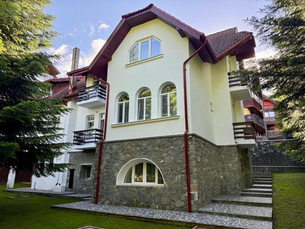 a house with a stone facade at Shiro Nord in Predeal