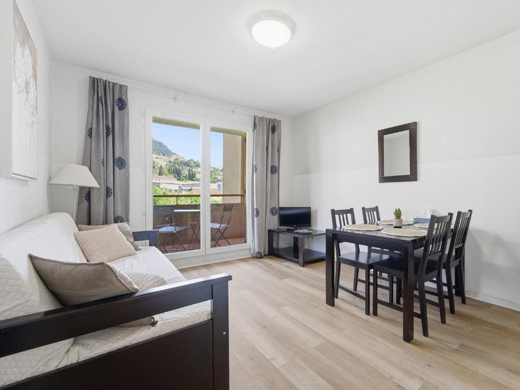 a living room with a table and a dining room at Virginia N214 2P4 in Grasse