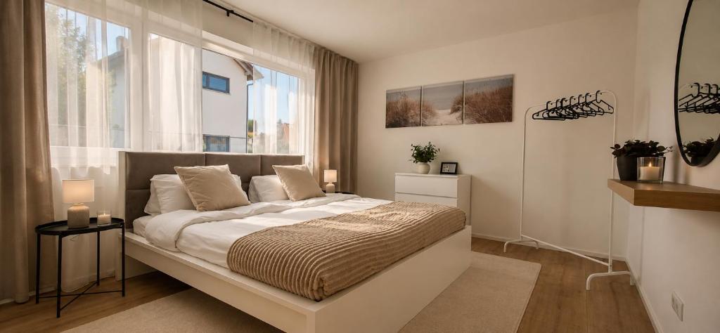 a bedroom with a large bed and a large window at Apartment Illerblick in Dettingen an der Iller