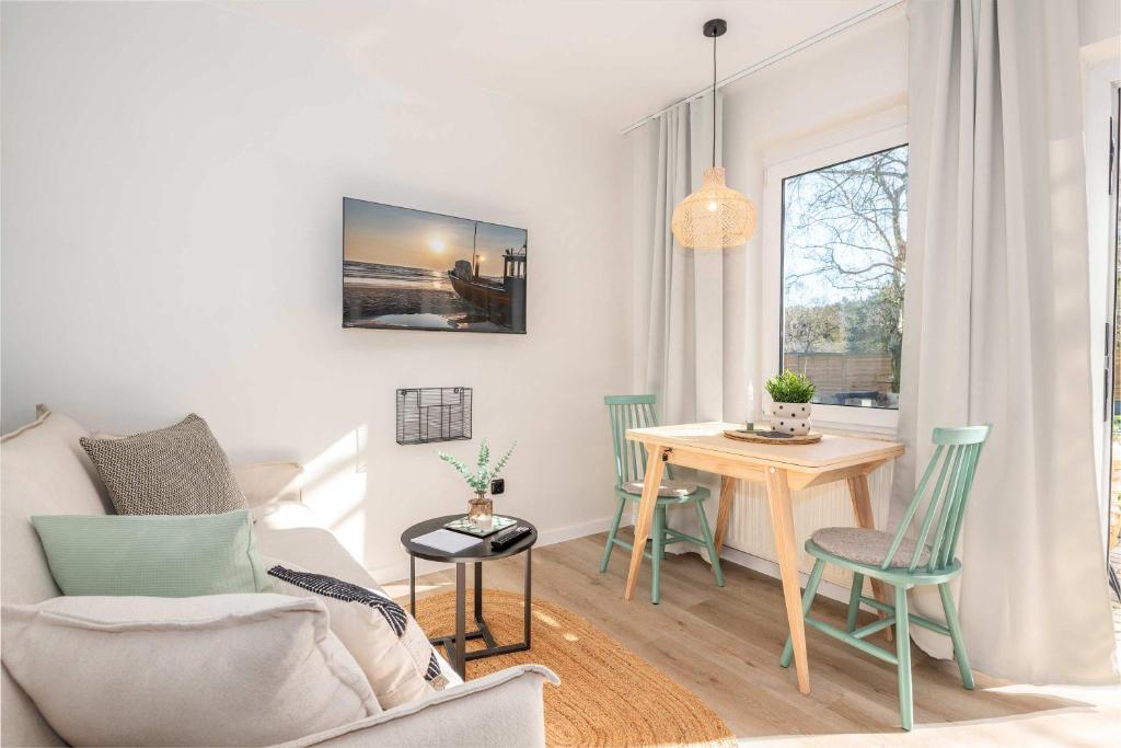a living room with a table and a couch at Green Village Igelnest in Benz