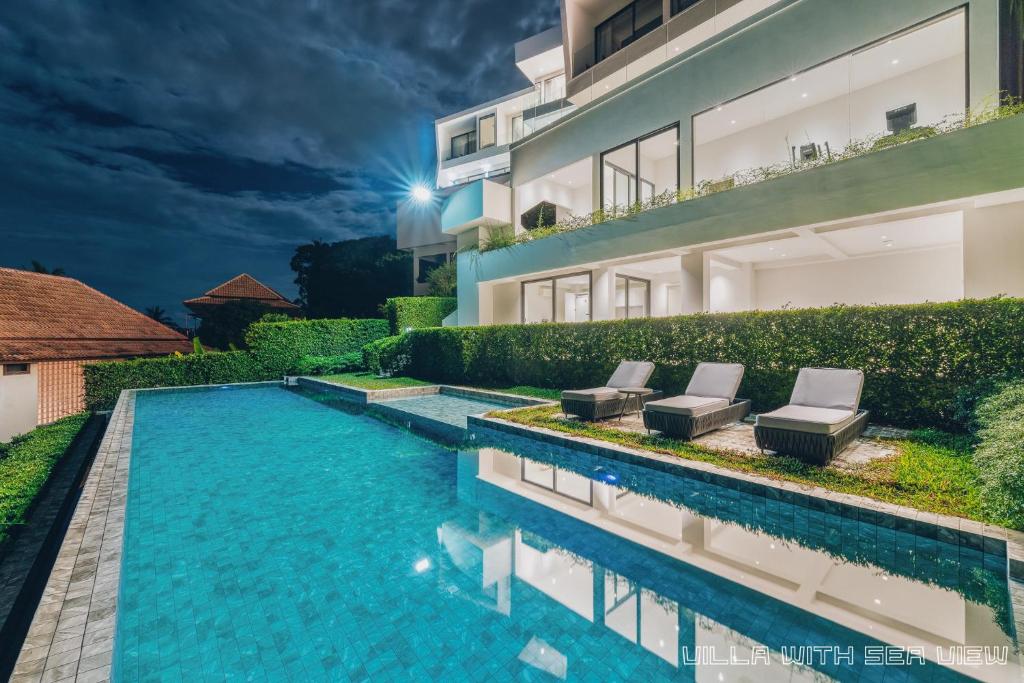 a swimming pool in front of a building at AAA villa in Ban Bang Po
