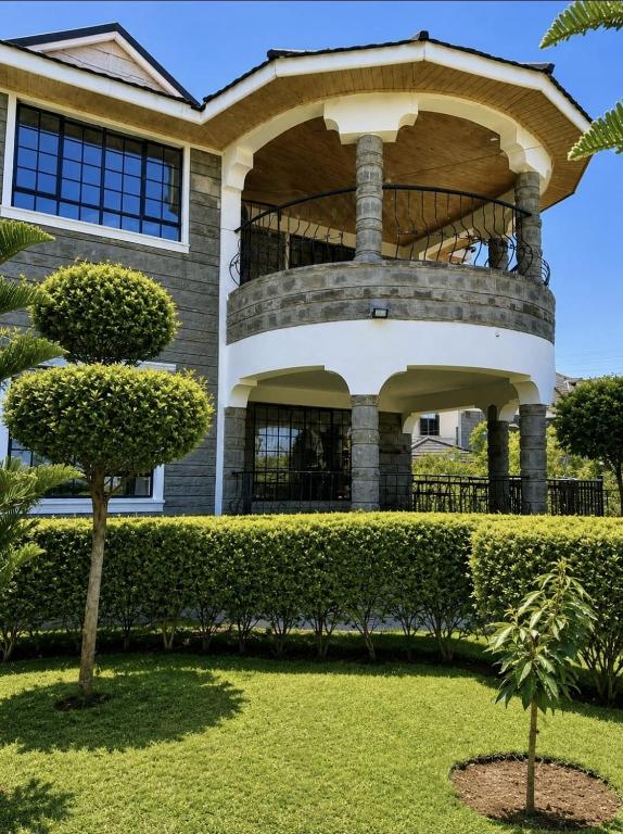 a house with a tree in front of it at Rhacky Homes - Near JKIA & SGR in Nairobi
