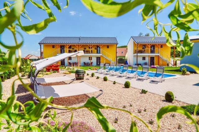 a playground with chairs and a slide in front of a house at Apartmány Milovice in Milovice