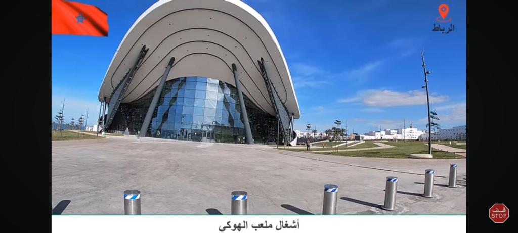 a large building with a glass facade in a parking lot at Akari said in Rabat