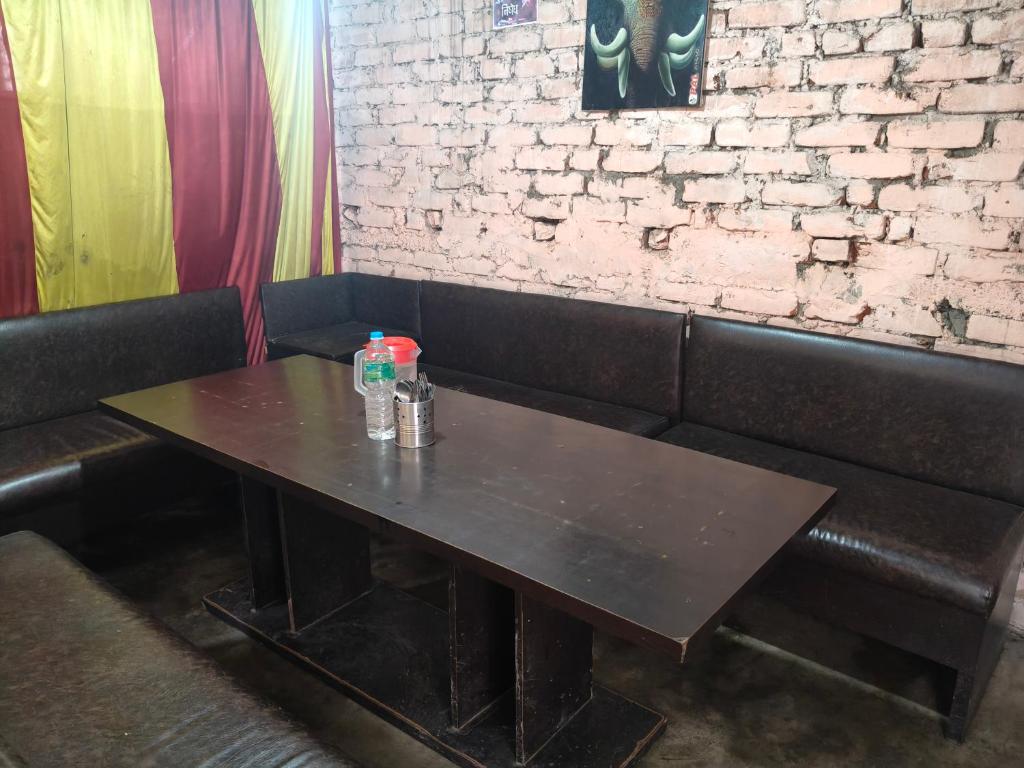 a table with two bottles of water on top of it at Ilam Pahuna Ghar in Ilām
