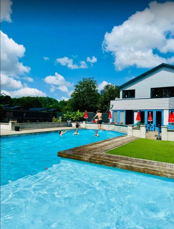 a group of people swimming in a swimming pool at Camping 3 étoiles - Piscine - ccbgaia in Châtel-Chéhéry